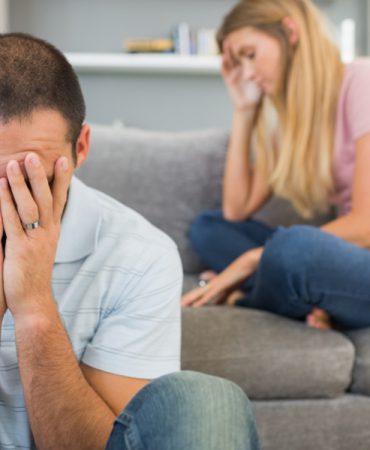 Couple having difficulties in sitting room at home